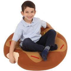 boy smiling while sitting cross legged on the Mushy Smushy Donut
