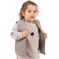 Toddler girl happily wearing the gray Honeycomb Weighted Vest