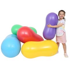 Girl smiling while holding the purple Peanut Ball alongside 4 more peanut balls in colors blue, green, red, yellow