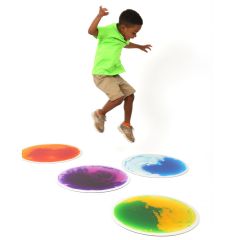 Boy jumping happily on the Round Gel Floor Tiles 