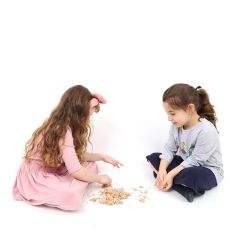 Two girls playing with the Weighted Dino Sand